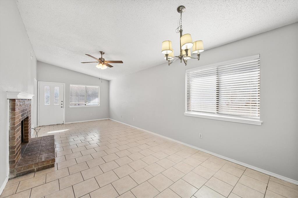 5821 Mansfield Road Arlington, TX 76017 - Photo 6 of 24 a view of a livingroom with a chandelier fan and windows