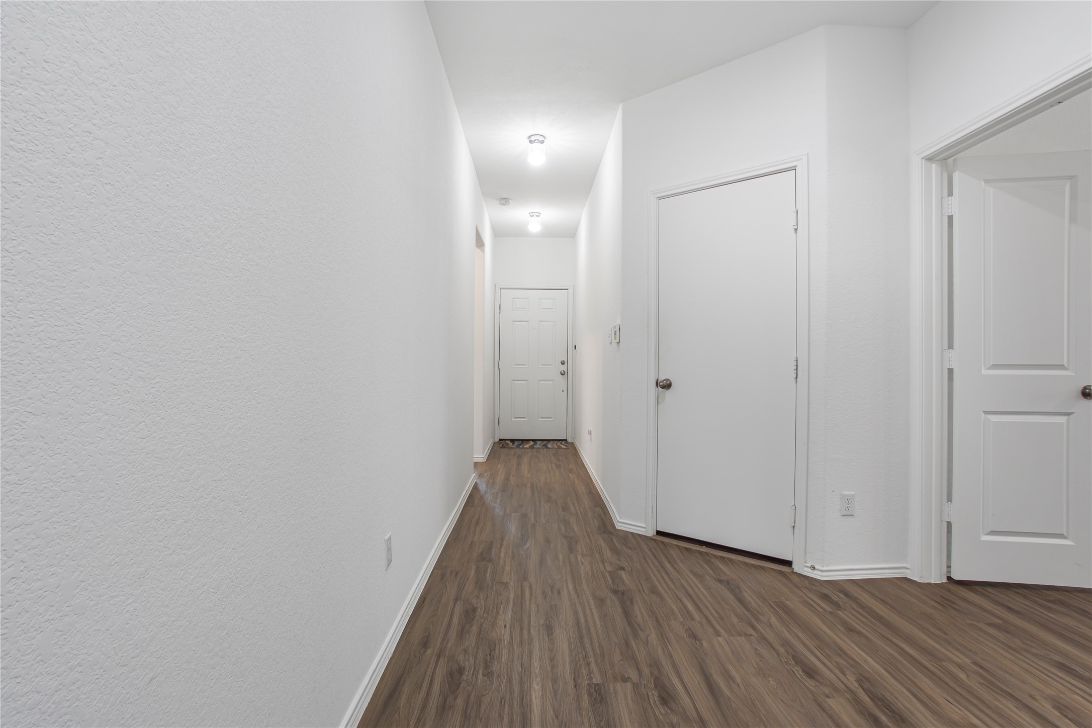 124 Cherry Ridge Road Georgetown, TX 78628 - Photo 4 of 23 Hallway featuring wood-finish flooring, white walls, and recessed lighting