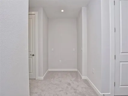 an empty room with a window and a ceiling fan