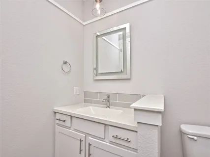 a bathroom with a sink a mirror and a window
