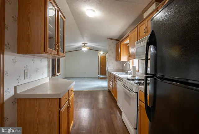 a kitchen with sink cabinets and stainless steel appliances