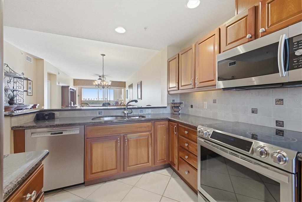 13113 Gasparilla Road, Unit 403 Placida, FL 33946 - Photo 9 of 62 a kitchen with a sink stove and microwave