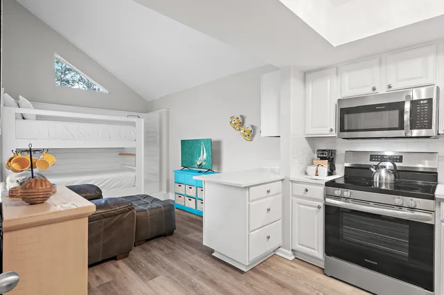 a kitchen with a sink stove and microwave