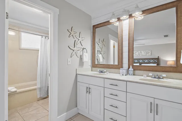 a bathroom with a double vanity sink mirror and shower