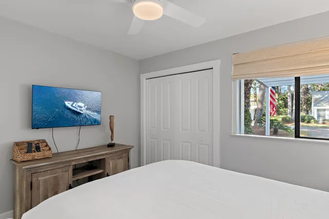 a bedroom with a bed and a flat screen tv