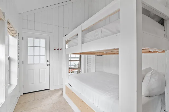 a spacious bedroom with a bed and a window