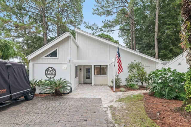 a view of a house with a yard and sitting area