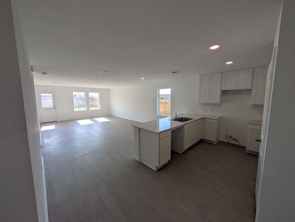 313 Nicholas Road Wharton, TX 77488 - Photo 2 of 15 a view of an empty room with window and wooden floor