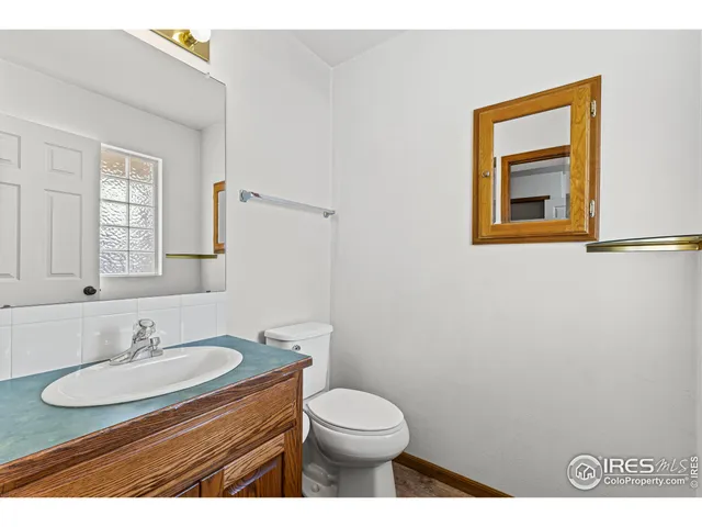 a bathroom with a sink toilet and mirror