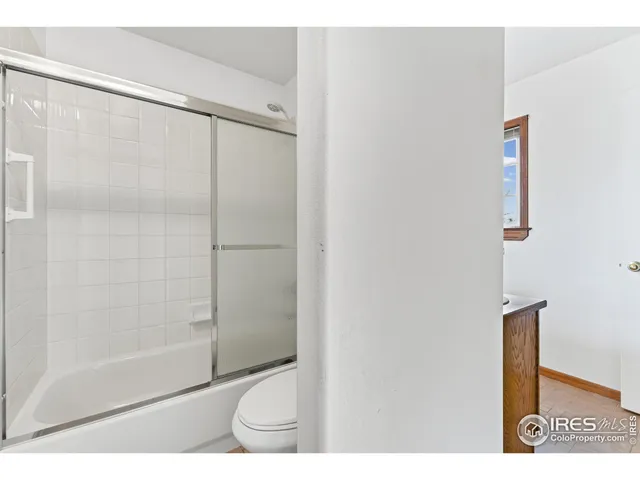 a bathroom with a shower and a toilet