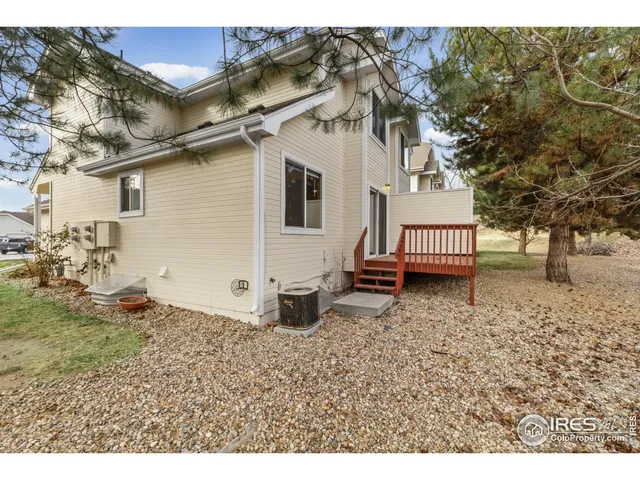 a backyard of a house with barbeque oven table and chairs