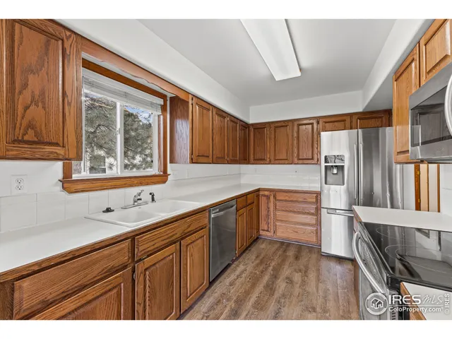 a kitchen with stainless steel appliances a refrigerator and a sink
