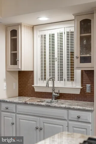 a kitchen with granite countertop next to a window