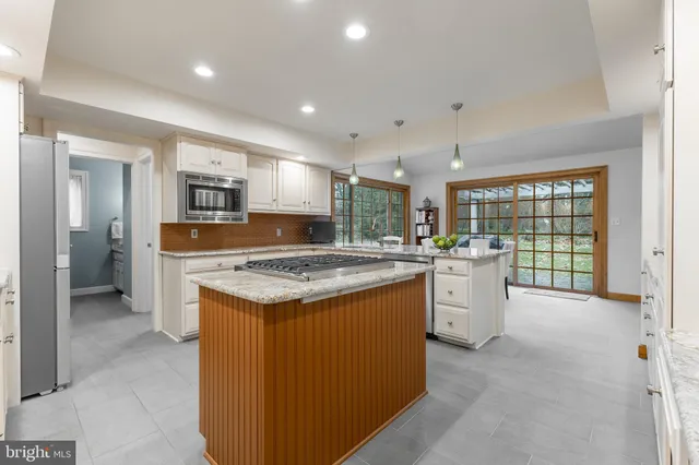 a kitchen with stainless steel appliances granite countertop sink refrigerator and microwave