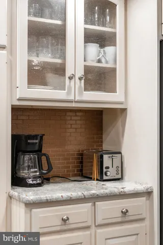 a stove top oven sitting inside of a kitchen