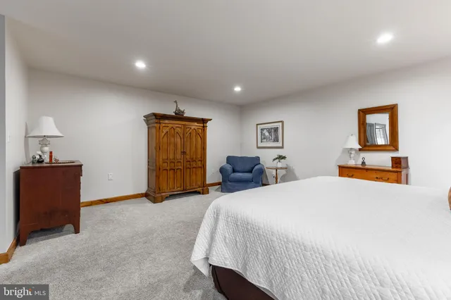 a spacious en suite bathroom with a double vanity sink and a mirror