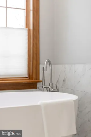 a spacious bedroom with a bed and a window