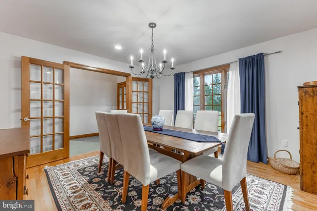 a dining room with furniture a rug and wooden floor