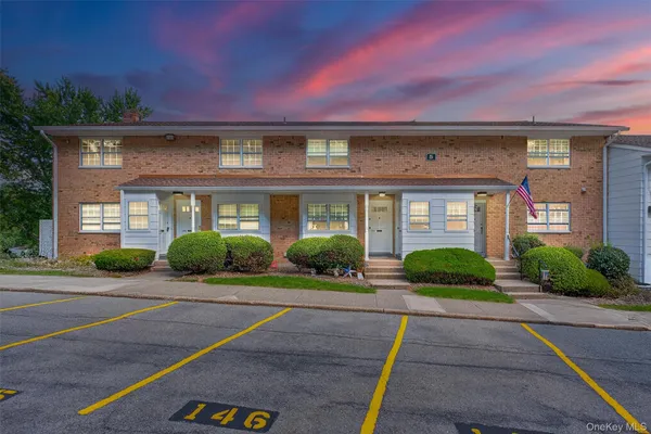 a front view of a house with yard and green space