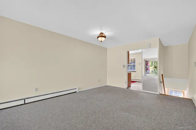 a view of a livingroom with wooden floor and a ceiling fan