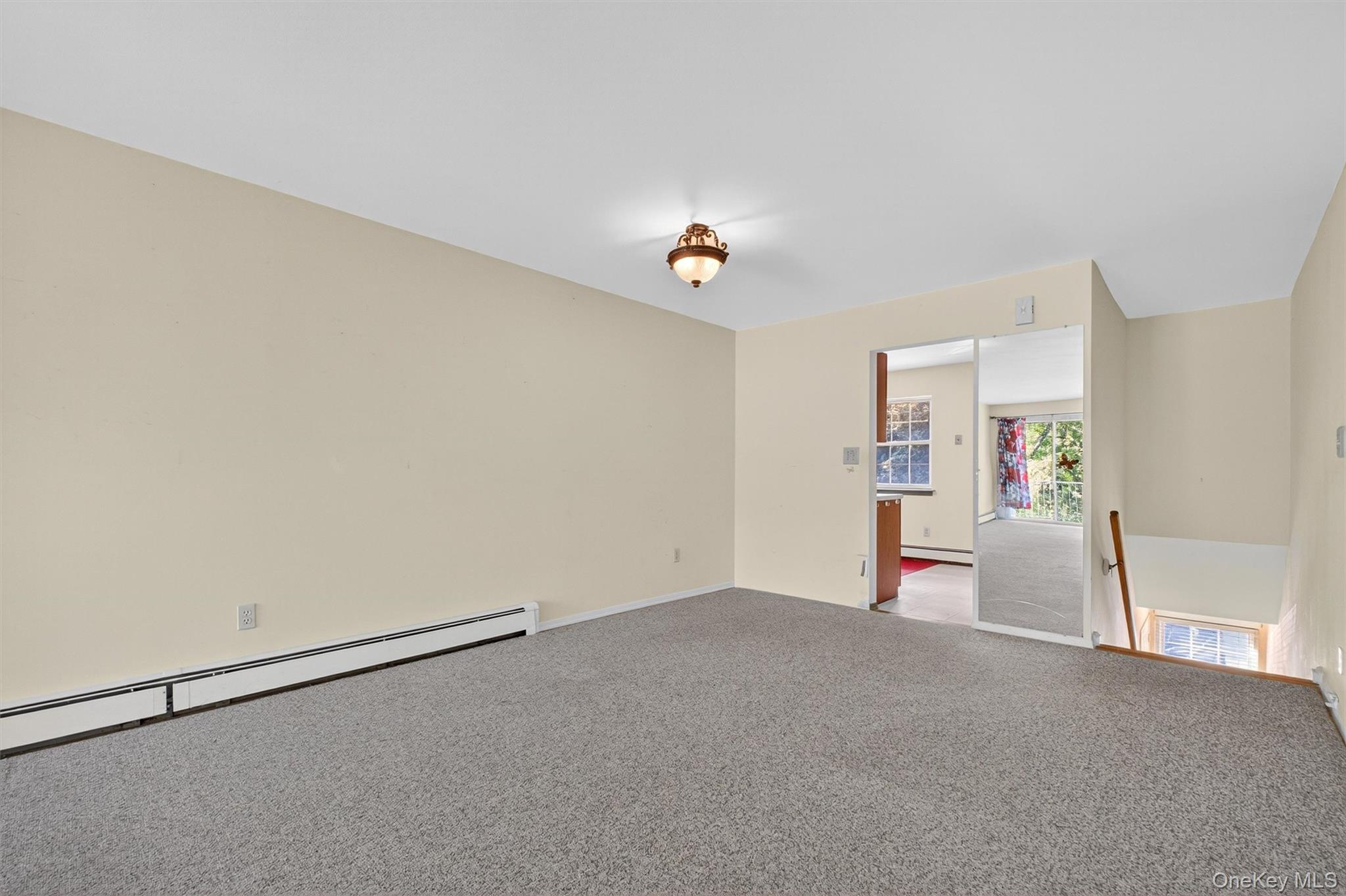 1840 Crompond Road, Unit 5C8 Peekskill, NY 10566 - Photo 11 of 36 a view of a livingroom with wooden floor and a ceiling fan