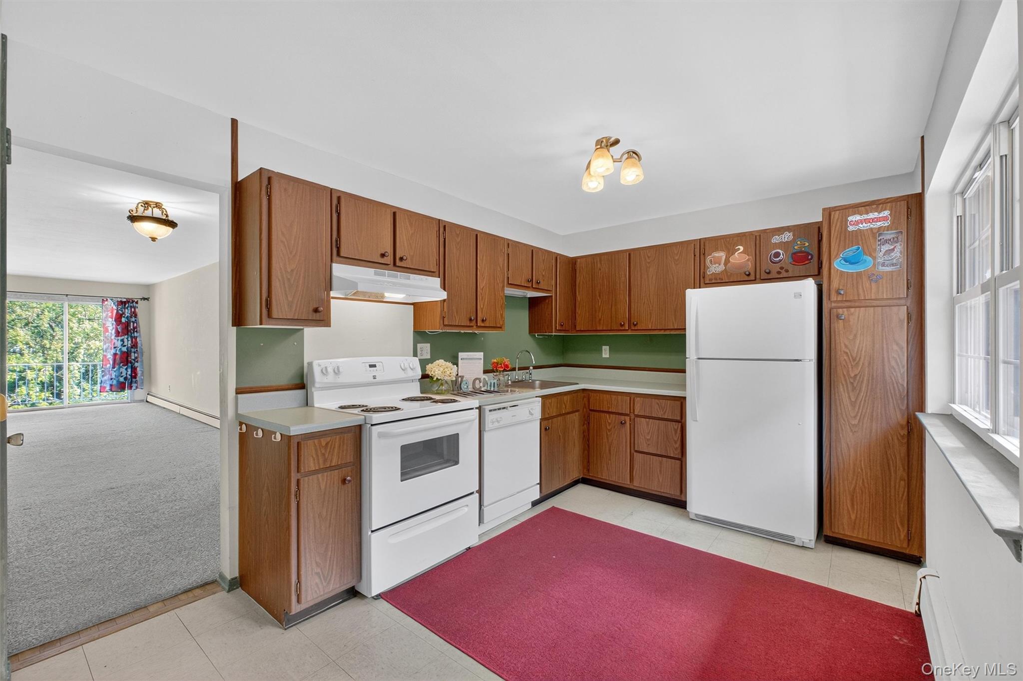 1840 Crompond Road, Unit 5C8 Peekskill, NY 10566 - Photo 17 of 36 a kitchen with a stove a sink and a refrigerator