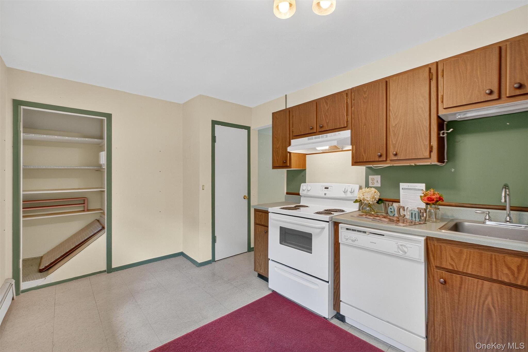 1840 Crompond Road, Unit 5C8 Peekskill, NY 10566 - Photo 19 of 36 a kitchen with a sink stove and cabinets