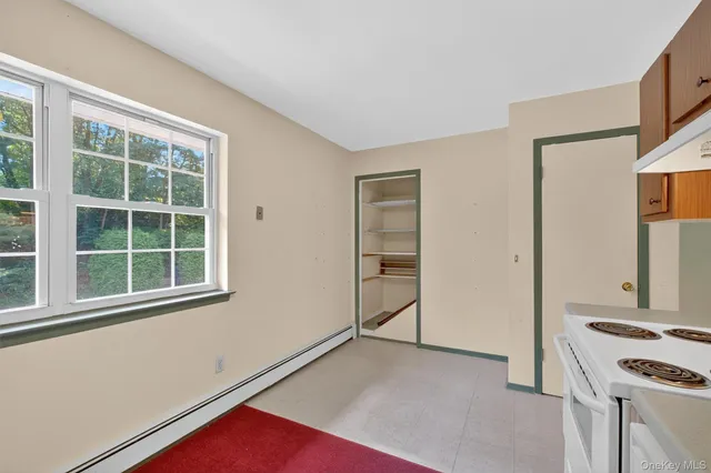 an empty room with window and wooden floor