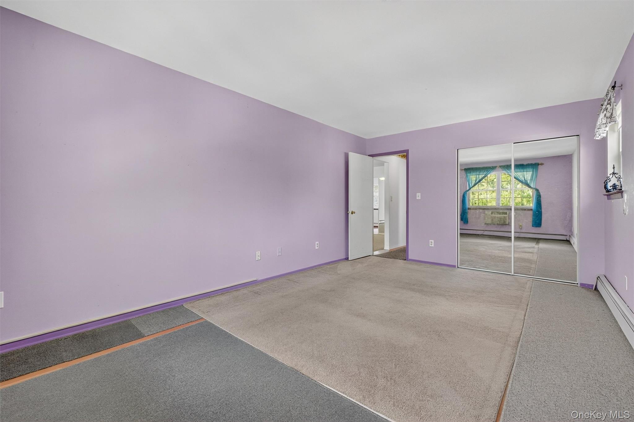 1840 Crompond Road, Unit 5C8 Peekskill, NY 10566 - Photo 22 of 36 an empty room with window and wooden floor