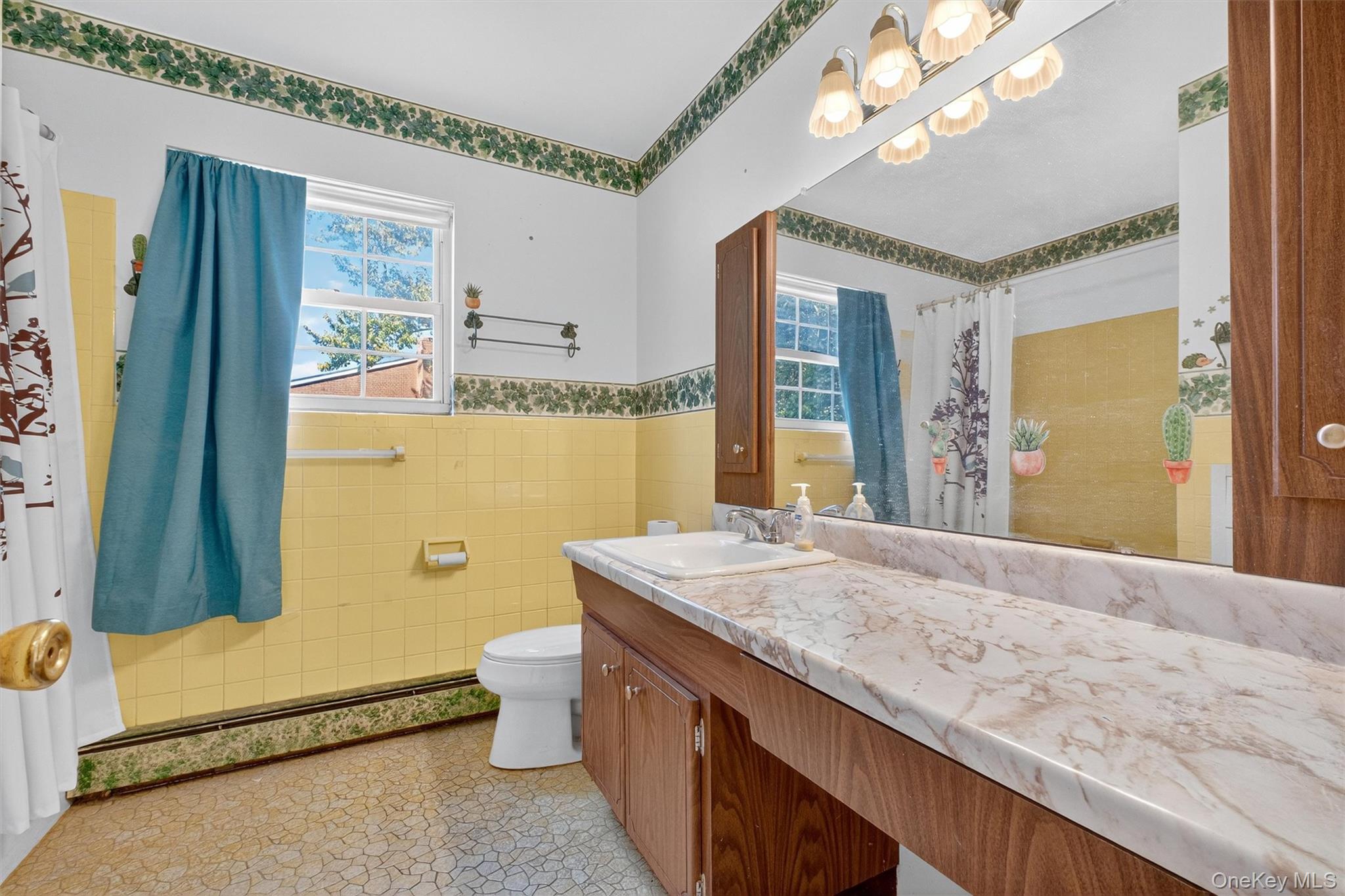 1840 Crompond Road, Unit 5C8 Peekskill, NY 10566 - Photo 24 of 36 a bathroom with a granite countertop sink a toilet a mirror and shower