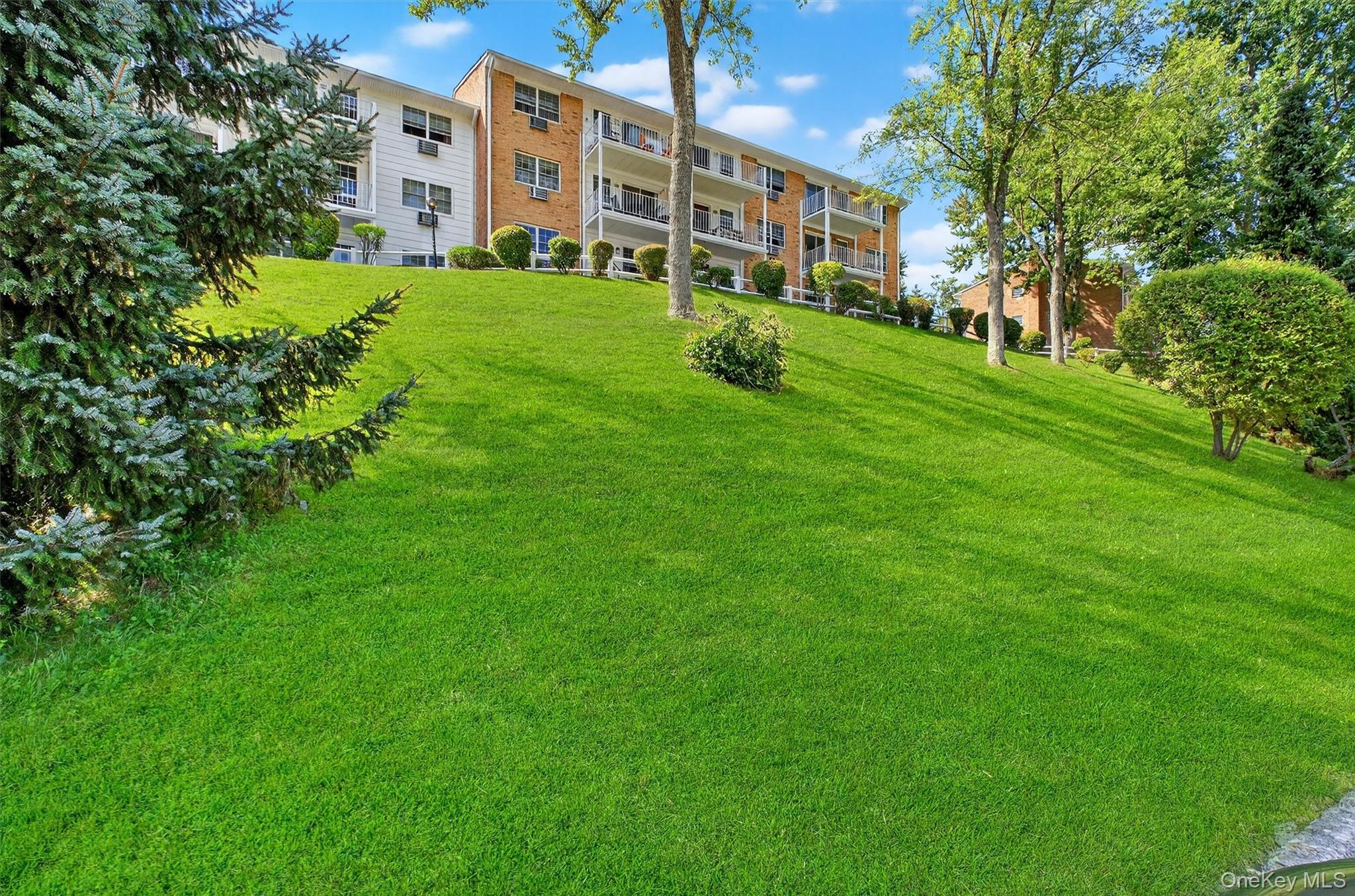 1840 Crompond Road, Unit 5C8 Peekskill, NY 10566 - Photo 30 of 36 a view of a building with a yard