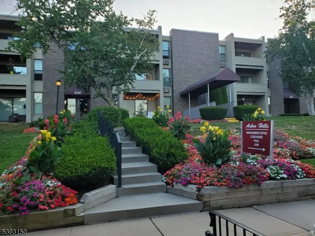 a front view of a house with a yard and a garden