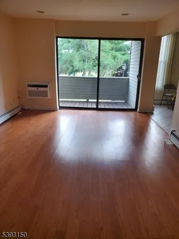 a view of room with window and wooden floor