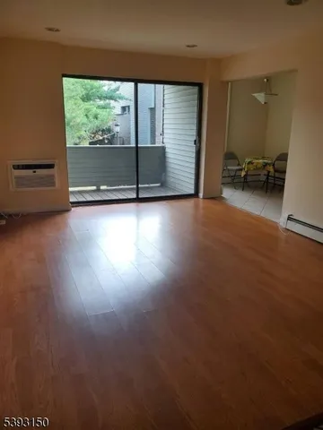 a view of room with window and wooden floor