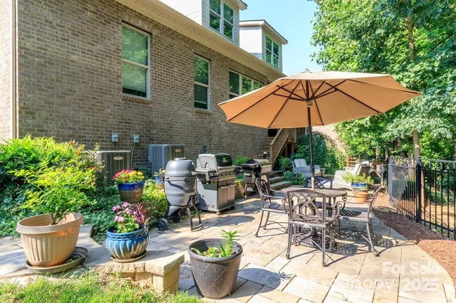 a view of a backyard with sitting area and garden