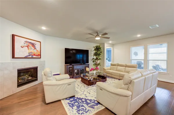 a living room with furniture a flat screen tv and a fireplace