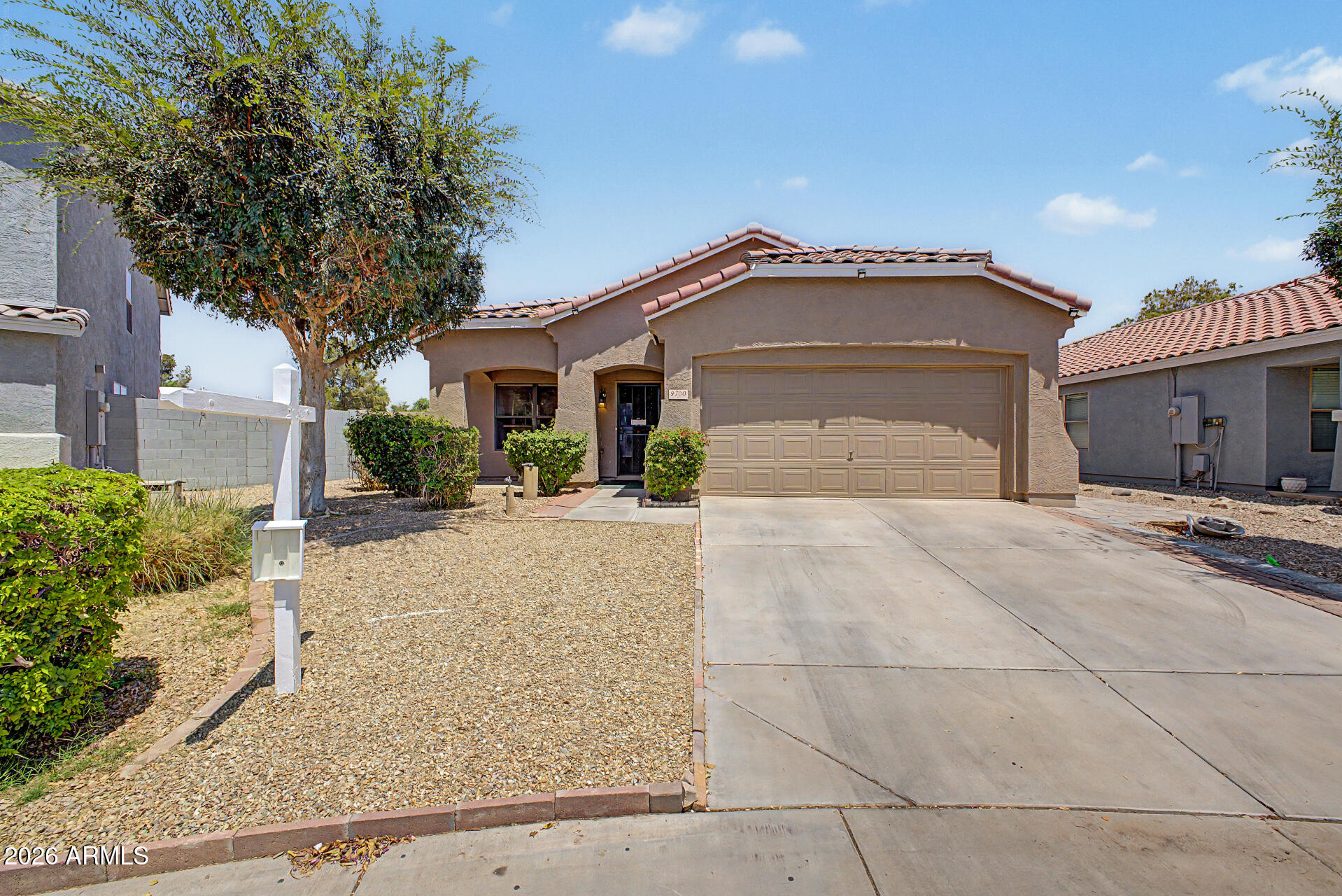 9730 West Payson Road Tolleson, AZ 85353 - Photo 1 of 57 a front view of a house with a yard and garage