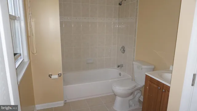 a view of a field with trees in the background