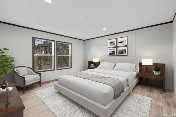 a spacious bedroom with a bed a couch and large window with outer view