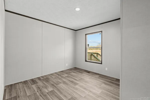 an empty room with windows and closet