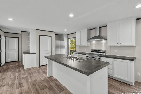 a kitchen with a sink stove and refrigerator