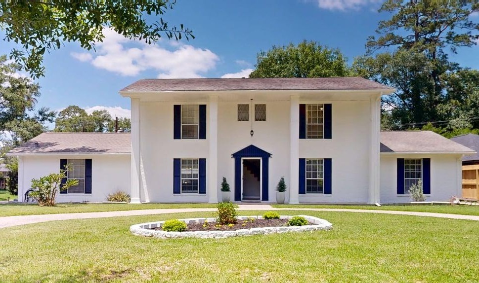 a front view of a house with a swimming pool