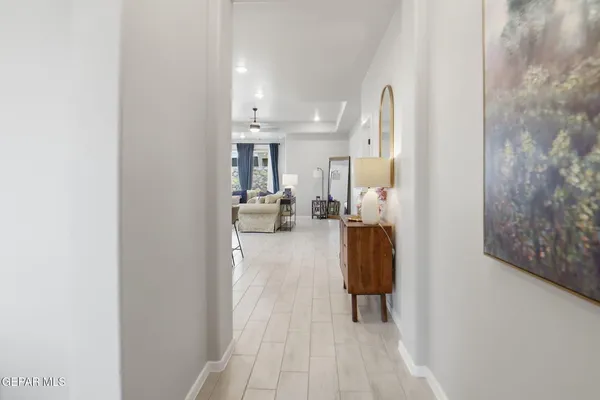 a living room with kitchen island furniture and chandelier