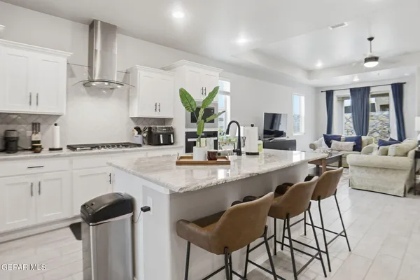 a kitchen with stainless steel appliances kitchen island a sink cabinets and wooden floor