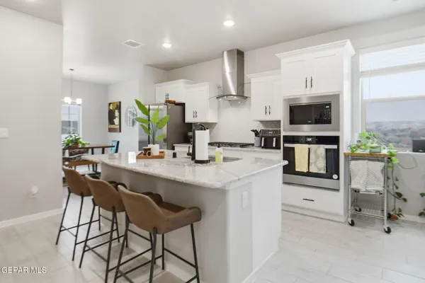 a kitchen with stainless steel appliances granite countertop a stove and a sink