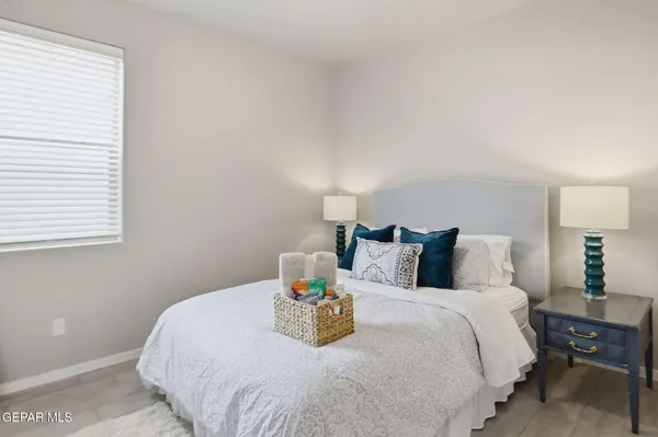 a bathroom with a granite countertop toilet sink and mirror