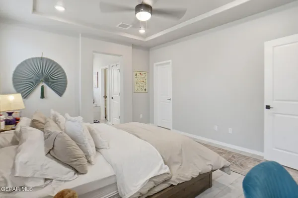 a bedroom with a bed and a large mirror