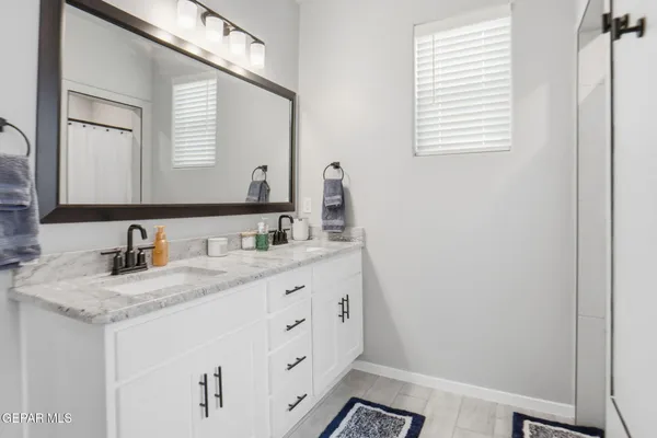 a bathroom with sinks granite and a mirror