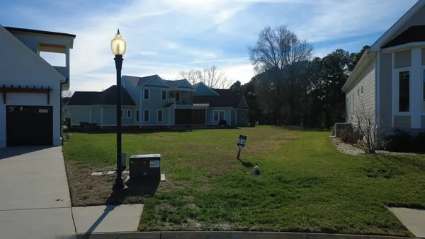 a view of house with a yard