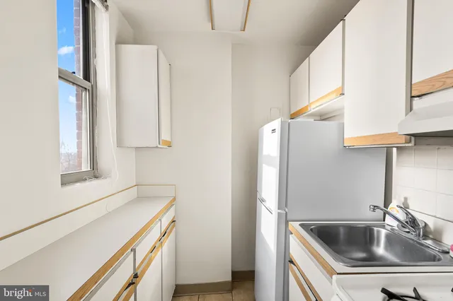 a kitchen with a sink cabinets and appliances